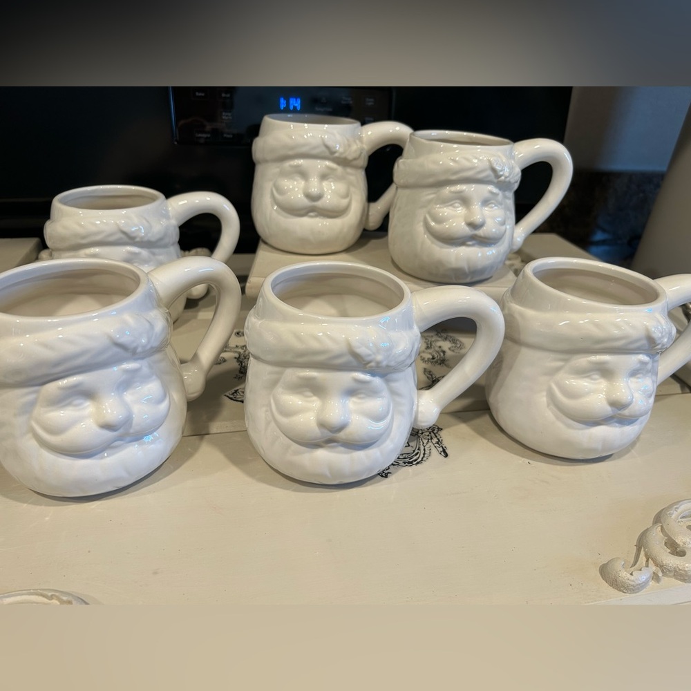 6 new condition large white Santa mugs.